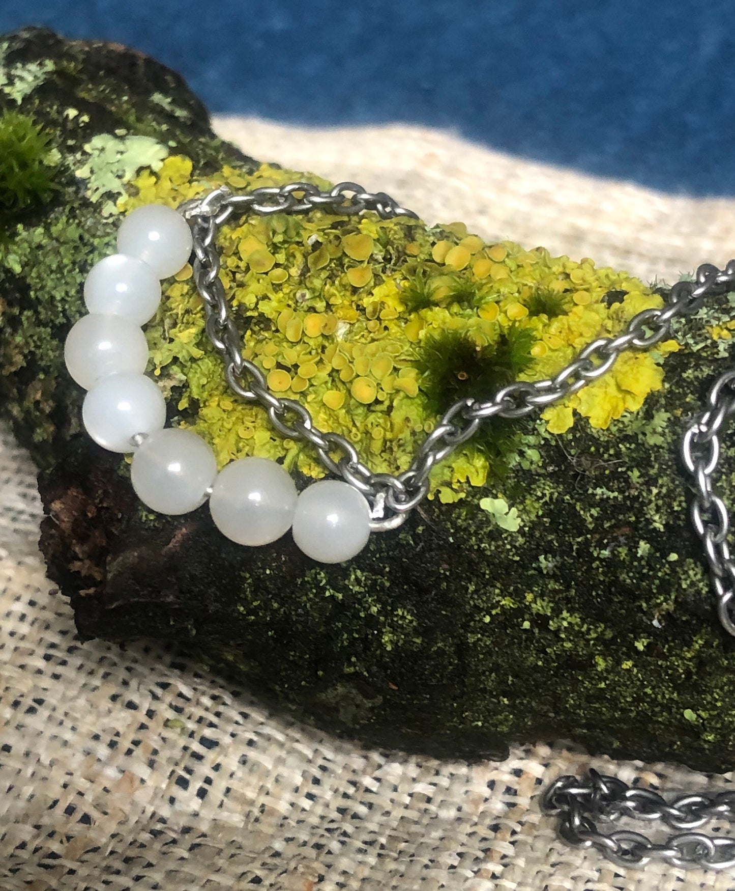 Moonstone & 9ct White Gold on a tumbled steel necklace.